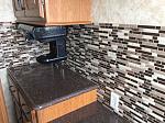 Removed old border and replaced it with peel and stick backsplash tile. Just starting to make it ours.